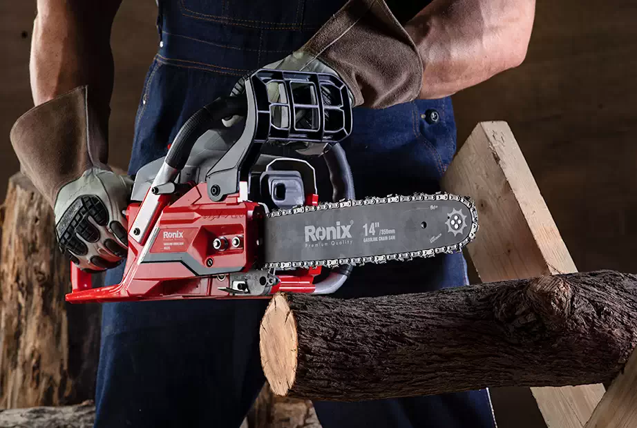 You should always hold the chainsaw with both hands and keep your body to the left of the chain line