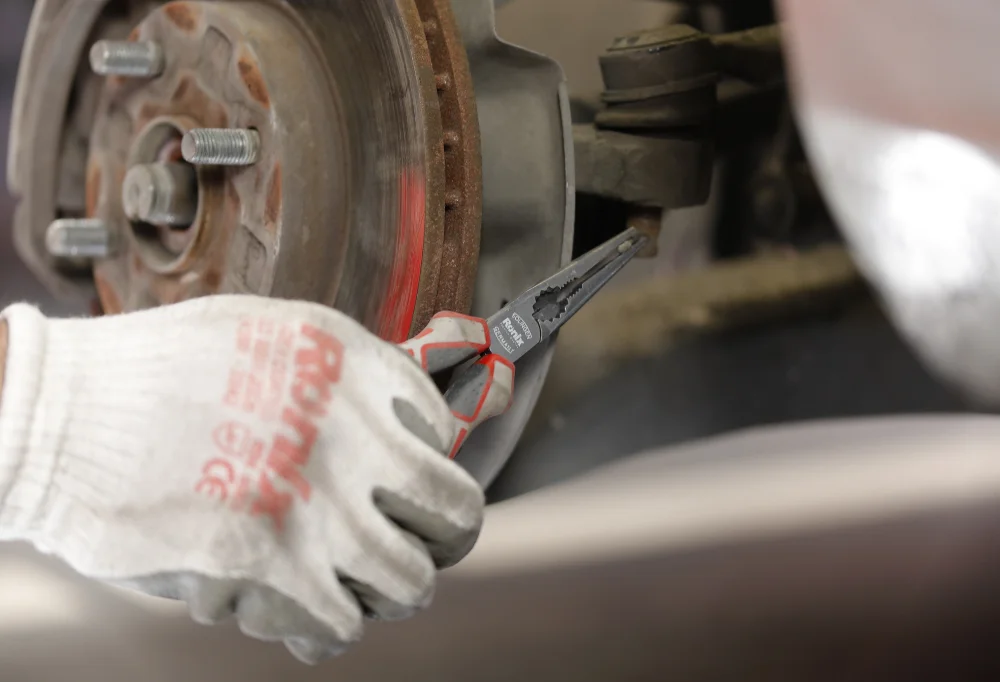 person using a plier to fix the wheel