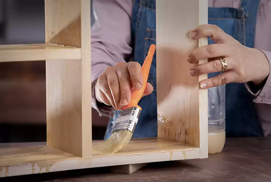 Applying sealer on the DIY wooden shelf