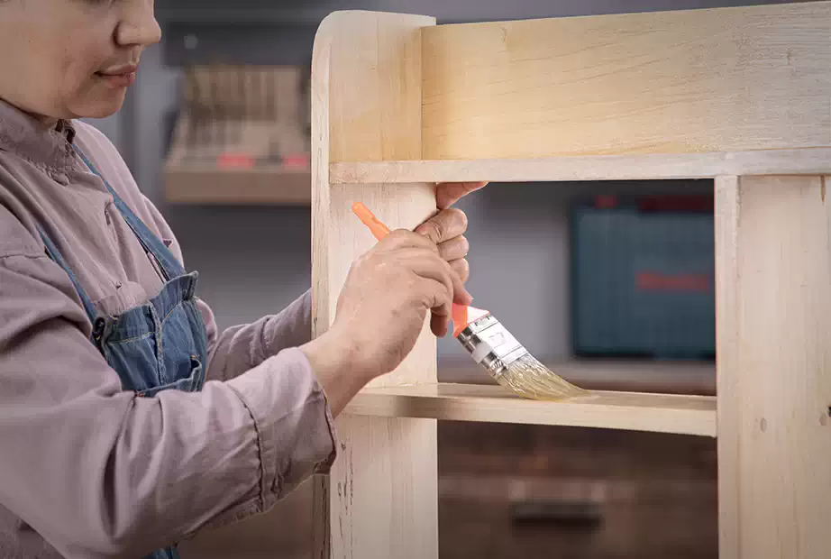 Applying a clear coat on the DIY wooden shelf