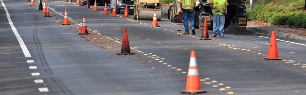 Road construction site with workers using PPE safety equipment